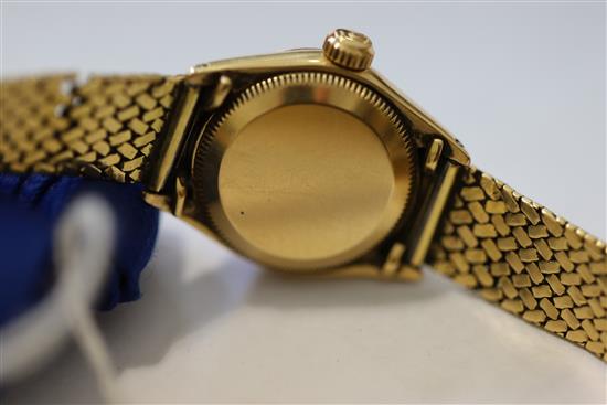 A ladys 18ct gold Oyster Perpetual Datejust Superlative Chronometer, having black dial with baton numerals (bracelet repaired)